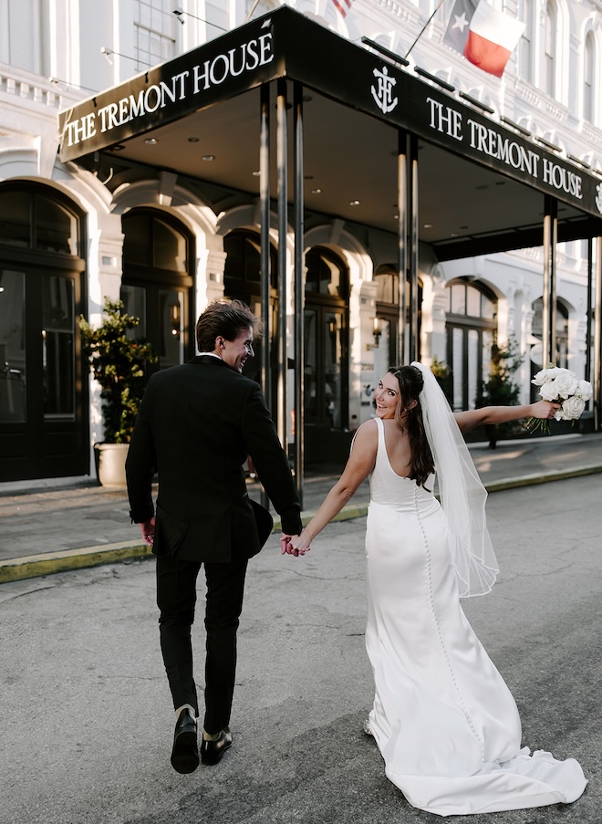The newlyweds run across the street toward The Tremont House. 