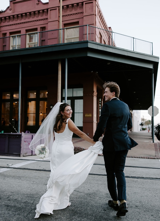 The bride and groom run across the street to the The Tremont House's ballroom.