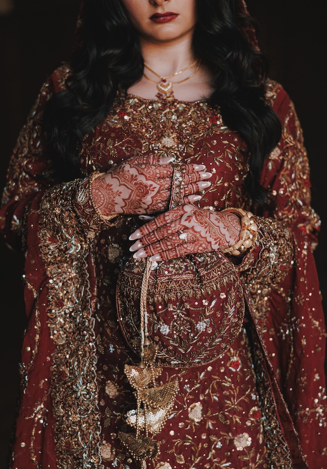 The bride's traditional bridal attire with red and gold beading. 