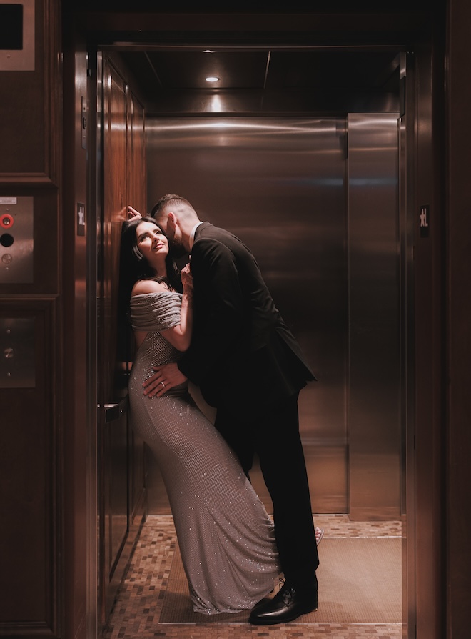 The groom kissing the bride's neck in the elevator. 