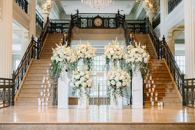 The altar framed with white floral arrangements at the Corinthian Houston. 