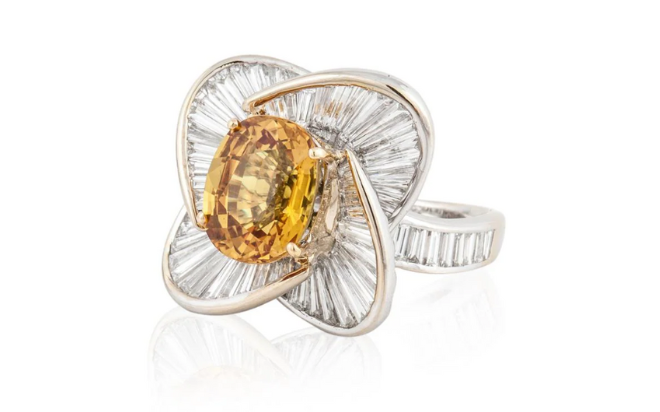 A white gold cluster ring with a sapphire diamond. 