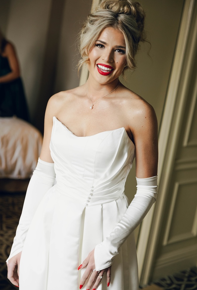 The bride wears a red lip for her wedding ceremony in Houston.