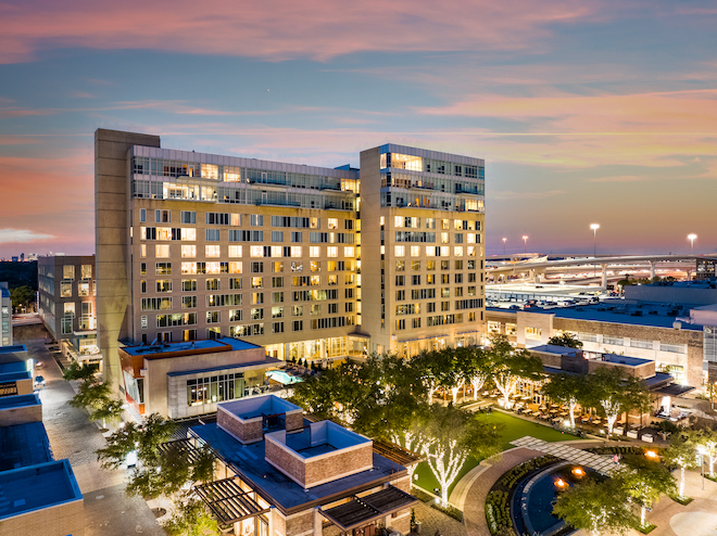 Outside of Texas hotel wedding venue  revealing a courtyard with trees and lights.