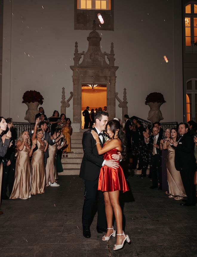 The bride wears a red mini dress for her send-off. 