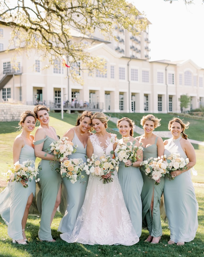 Bridesmaids wear sage green dresses for a Texas hill country wedding. 