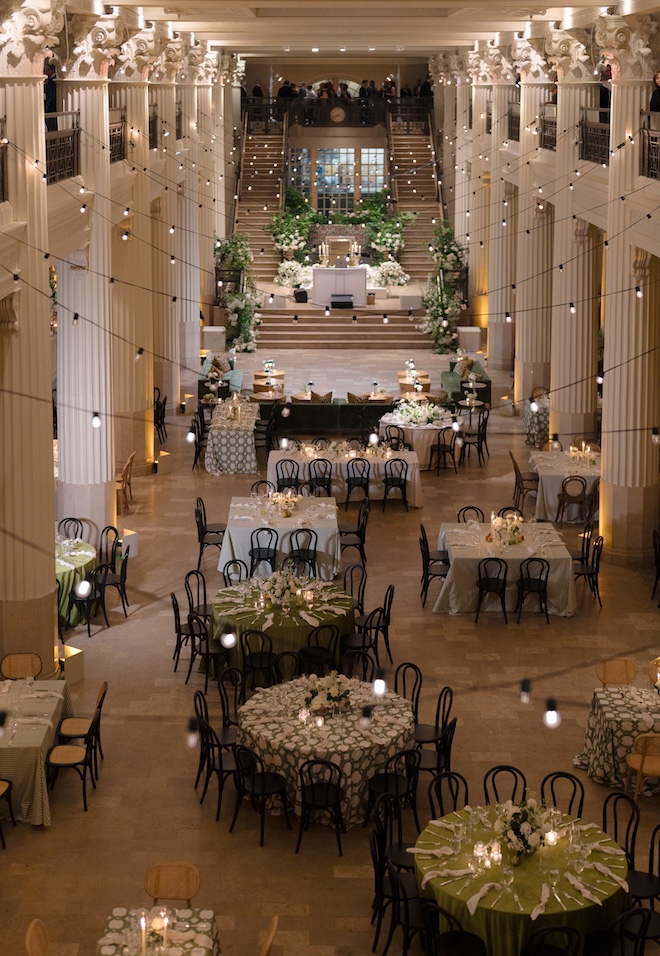 A wedding reception with different style seating, including green couches. 