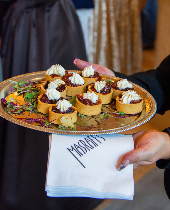 A server from Masraff's Catering passes hors d'oeuvres at the Corinthian Houston. 