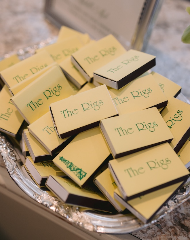 Yellow match boxes with green lettering that reads "The Rigs".