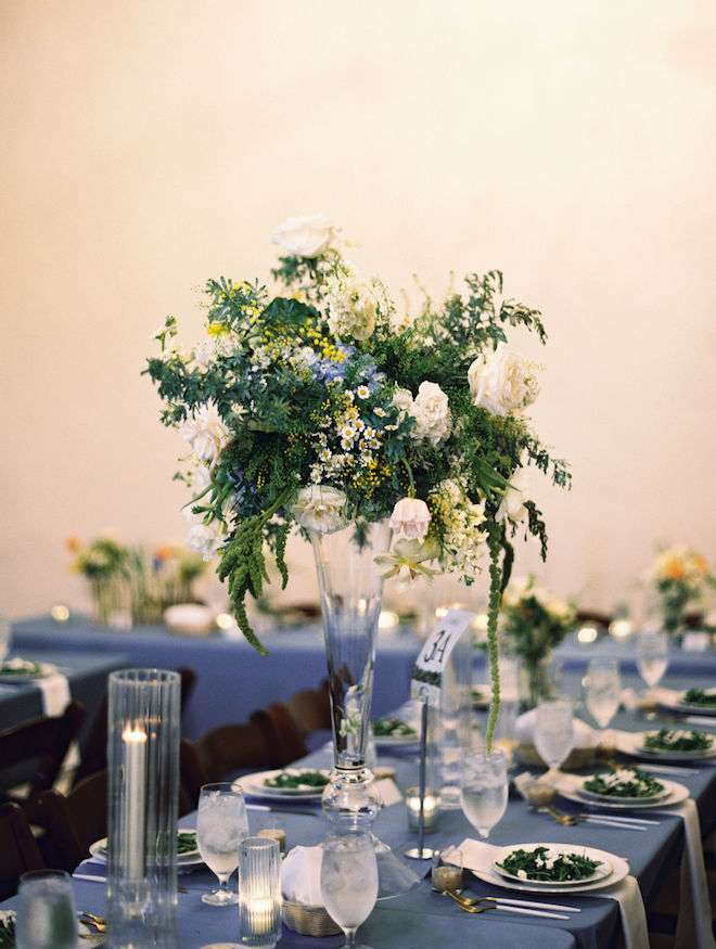 Close up of yellow, white, and hints of blue reception centerpiece bouquet.