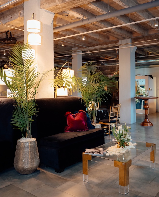 The Vault decorated with lounge seating, florals and jewel-toned pillows. 