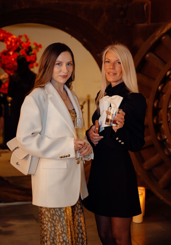 Tess of Epris Events and another guest posing in front of The Vault. 