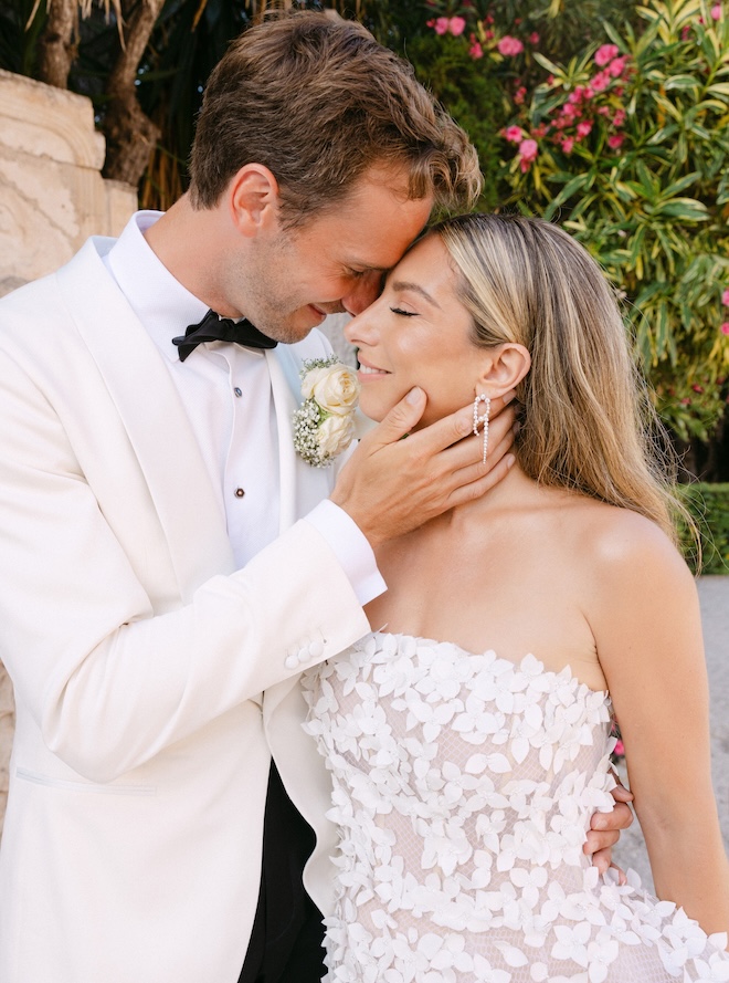 The couple embrace each other at their vibrant French Riviera wedding. 