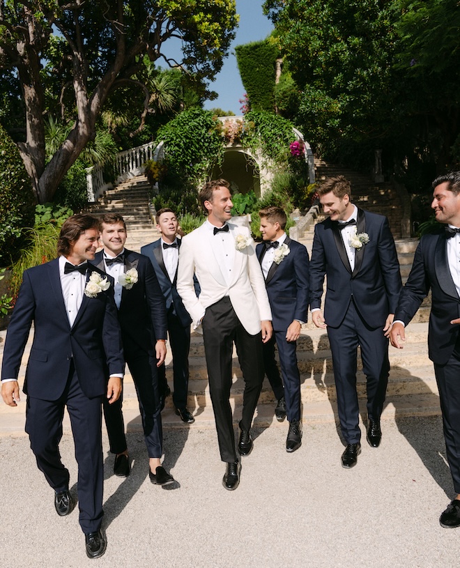 The groom and his groomsmen walk down the step of Villa et Jardins Ephrussi de Rothschild.