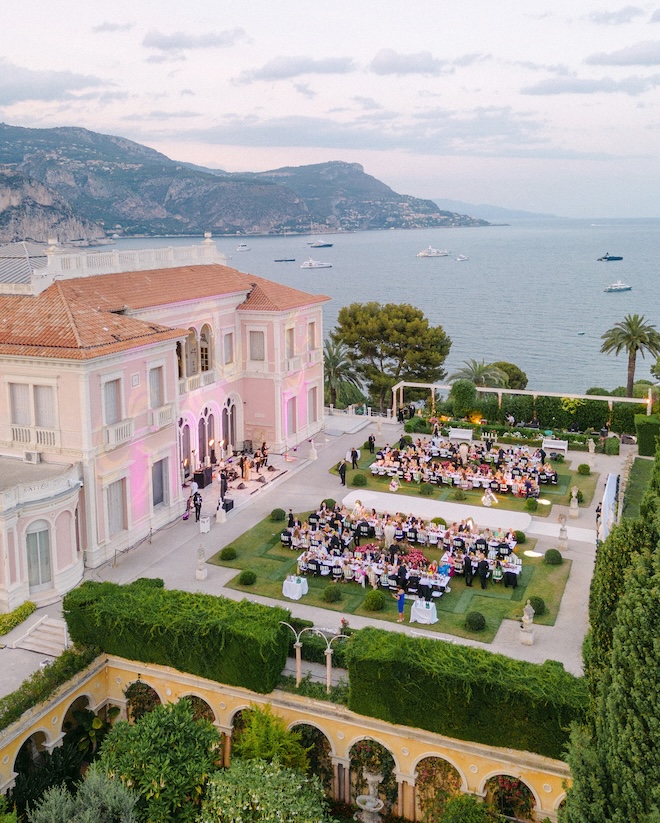 An outdoor reception of a vibrant French Riviera wedding overlooking the Mediterranean.