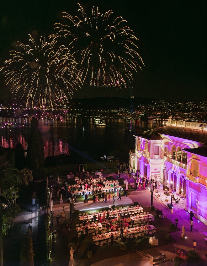 Fireworks light up the sky over a vibrant French Riviera wedding at a historic palace. 