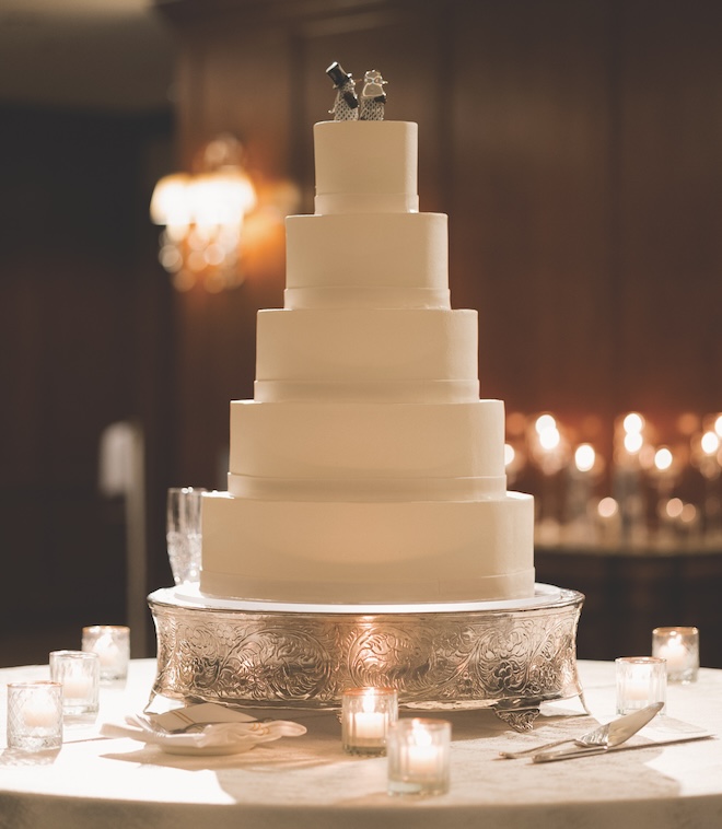 5-tier white wedding cake with Herend figurines on top. 