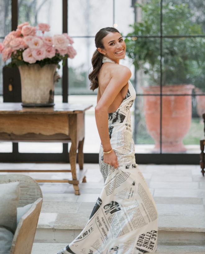 The bride wearing a custom newspaper gown for her rehearsal dinner. 