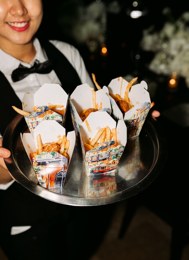 French fires are served in New Orleans inspired take out cartons. 