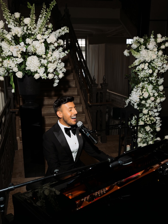 A piano player sings and plays the piano for the couples wedding ceremony. 