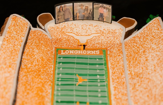 The groom's cake is the University of Texas Stadium with pictures of the couple. 