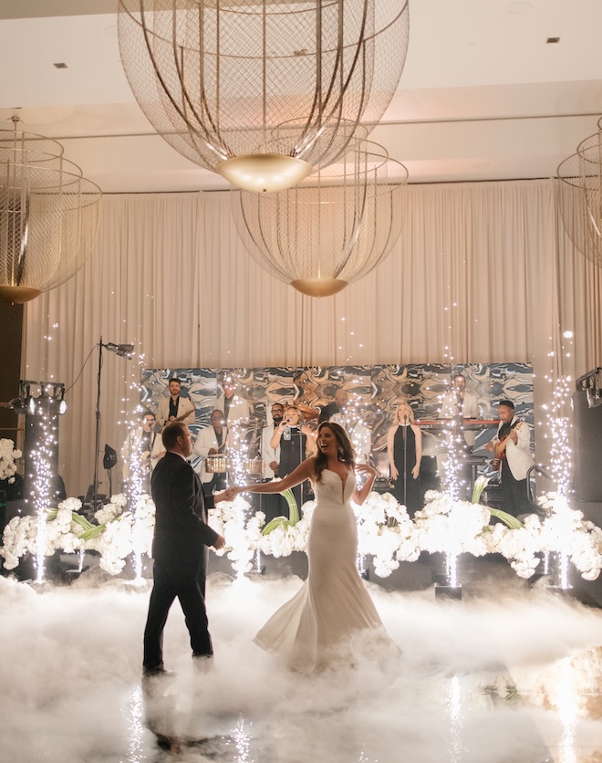 The bride and groom dance on the dance floor at their wedding reception.