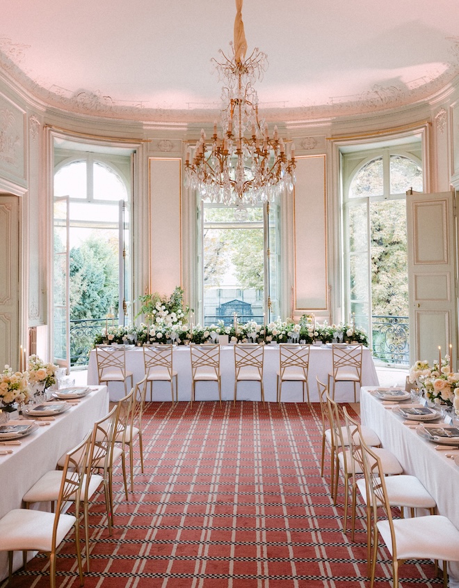 The reception space with long reception tables with florals and candles. 