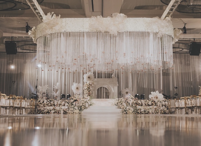 A floral hanging installation hangs over the dance floor of the reception at The Post Oak Hotel. 