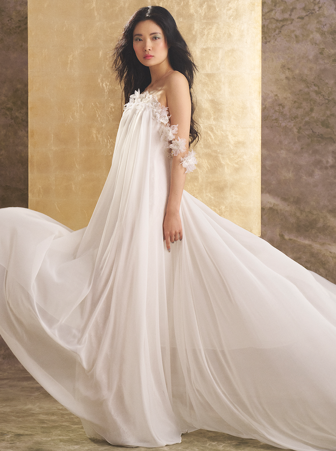 The model wears a flowy designer gown by Ines de Santo. 