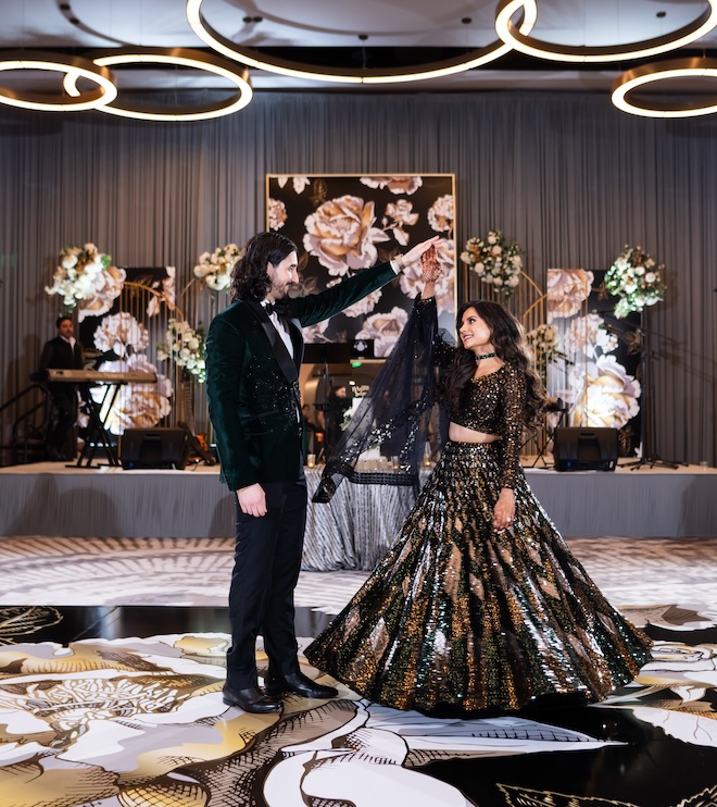 A bride and groom dancing on a black and gold dancefloor at Houston Marriott CityPlace at Springwoods Village. 