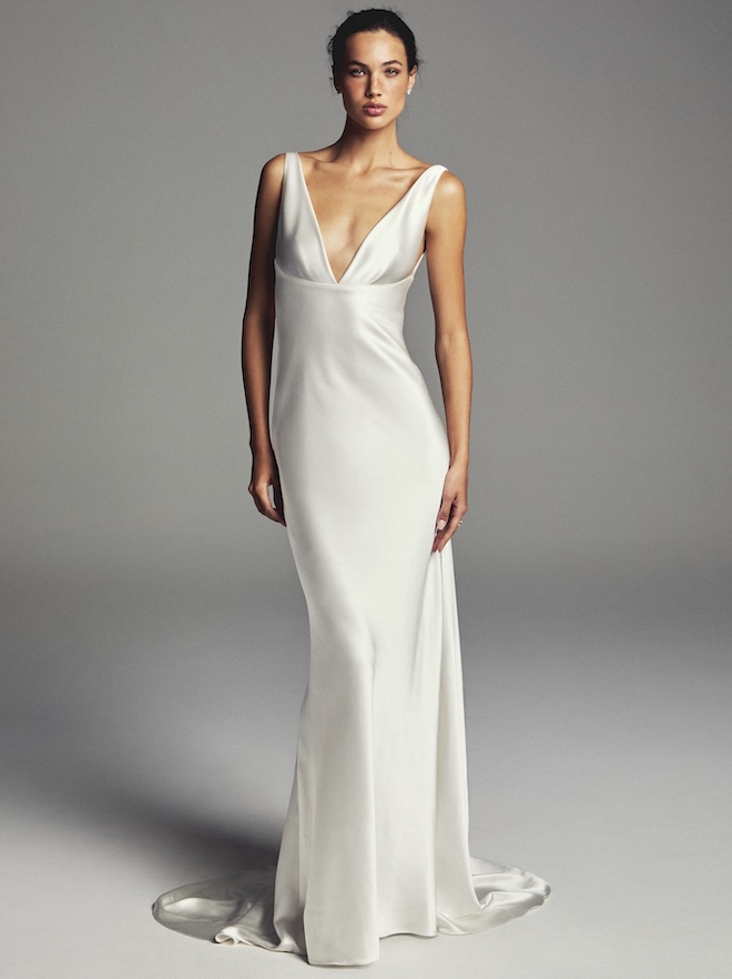 The model wears a sleek wedding gown by Monique Lhuillier's spring 2027 bridal looks. 