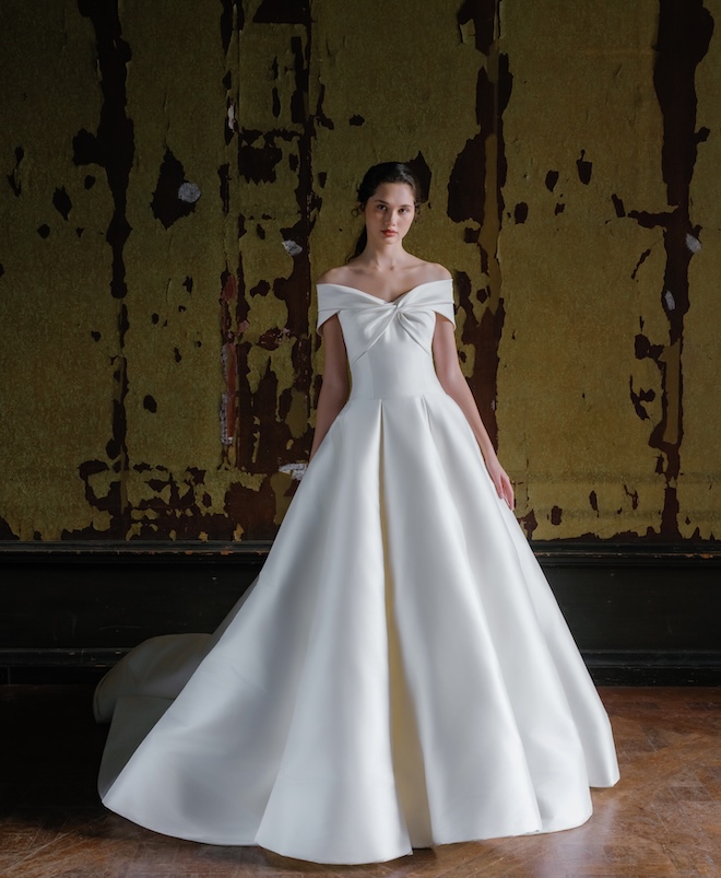 The model wears an off the shoulder wedding gown by Sareh Nouri. 