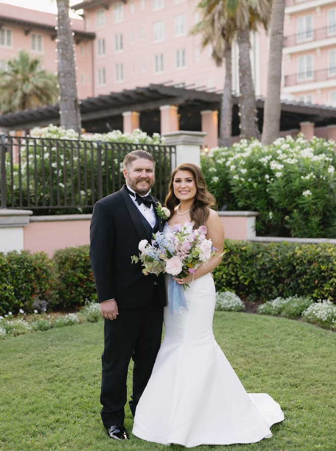 The couple smile in front of the Grand Galvez in Galveston.