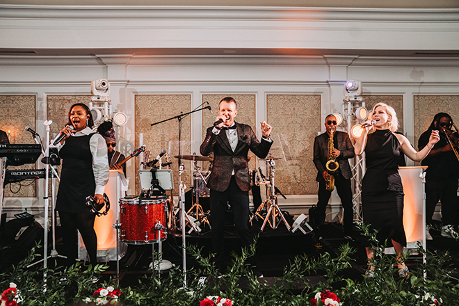 Houston wedding band, Danny Ray and The Atlantic Street Band, sings on stage at wedding reception.