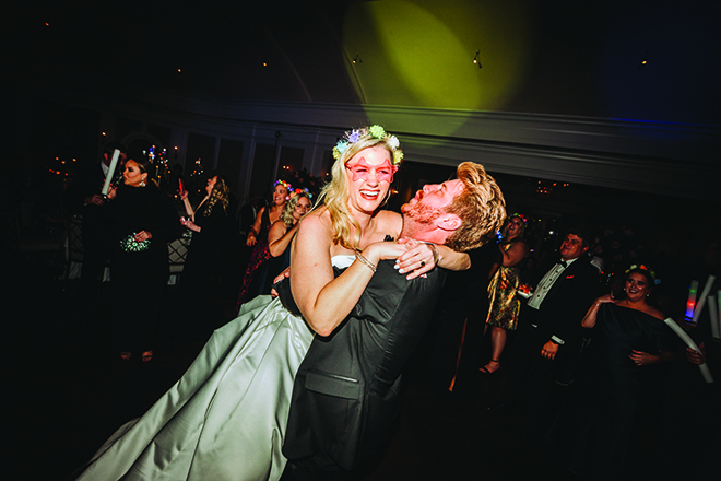 The bride and groom dance on the dance floor as Houston wedding band performs at their reception.
