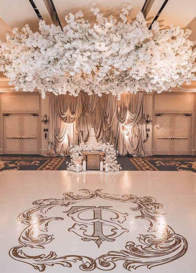 White florals hang above the dance floor and wedding cake at The Houstonian Hotel, Club and Spa. 