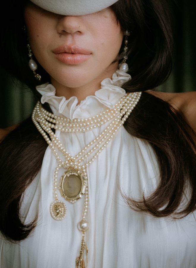 The model wears vintage jewelry and accessories with her wedding dress. 