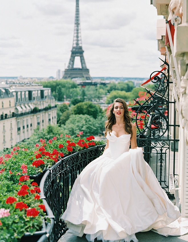 The bride walks along the terrace of Paris Hotel overlooking the Eiffel Tower.