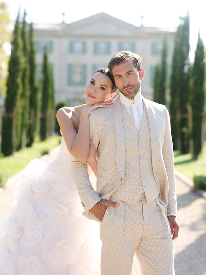 The couple smile outside Château de Torreau.
