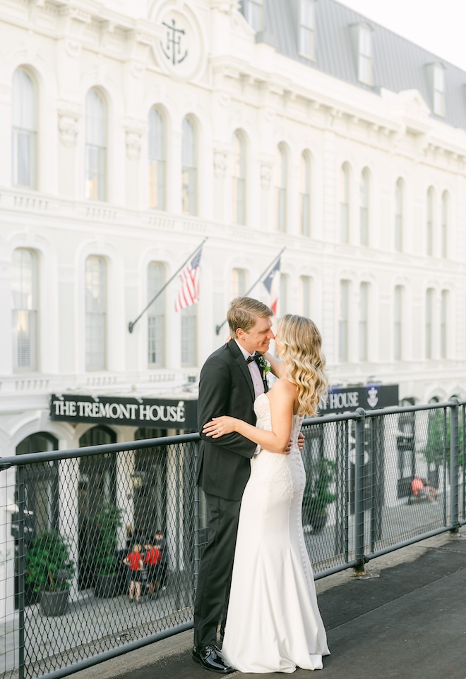 The bride and groom kiss on the terrace of the Davidson Ballroom at The Tremont House.