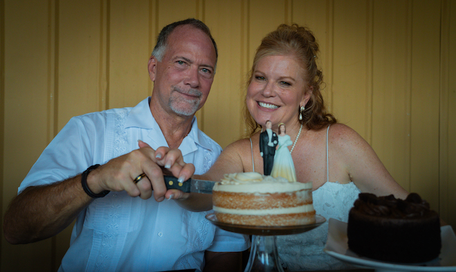 Bride and groom cutting the cake with a classic wedding topper at their Texas Wedding with an Intimate Wine Vineyard.