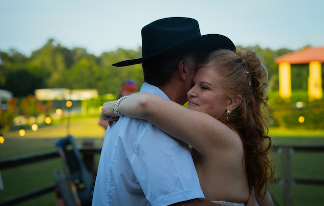 Newlyweds sharing their first dance at their Texas Wedding with an Intimate Wine Vineyard.