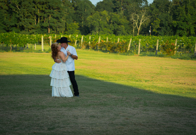 Newlyweds in open vineyard field for their Texas wedding.