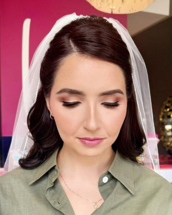 Bride gets her hair done by Blo Blow Dry Bar and is wearing a veil. 