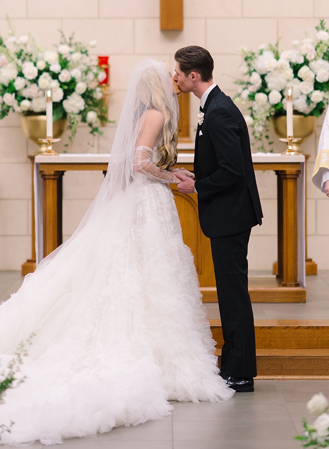 The couple kiss at the altar at their church ceremony in Houston.