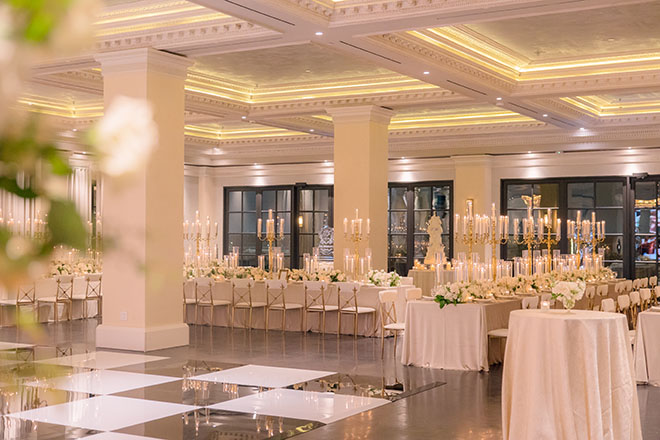 Candelabras and white flowers decorate the reception tables at Le Tesserae. 