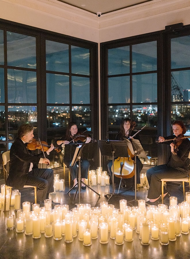 Violinists play at the couples Le Tesserae wedding reception.