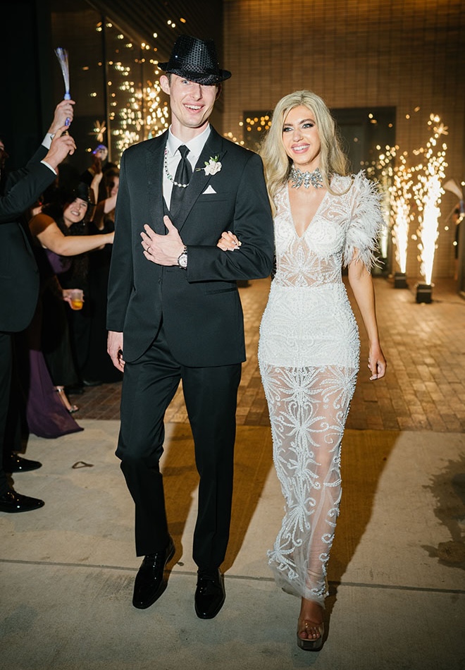The bride and groom exit their wedding reception in a sparkler send-off.
