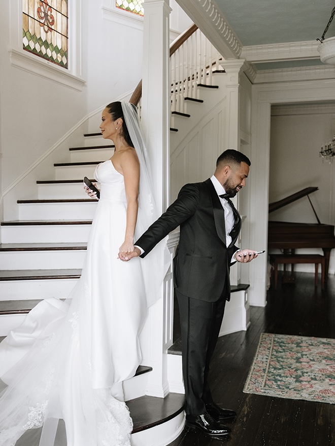 The couple holds hands as they have a private first touch and read their vows. 
