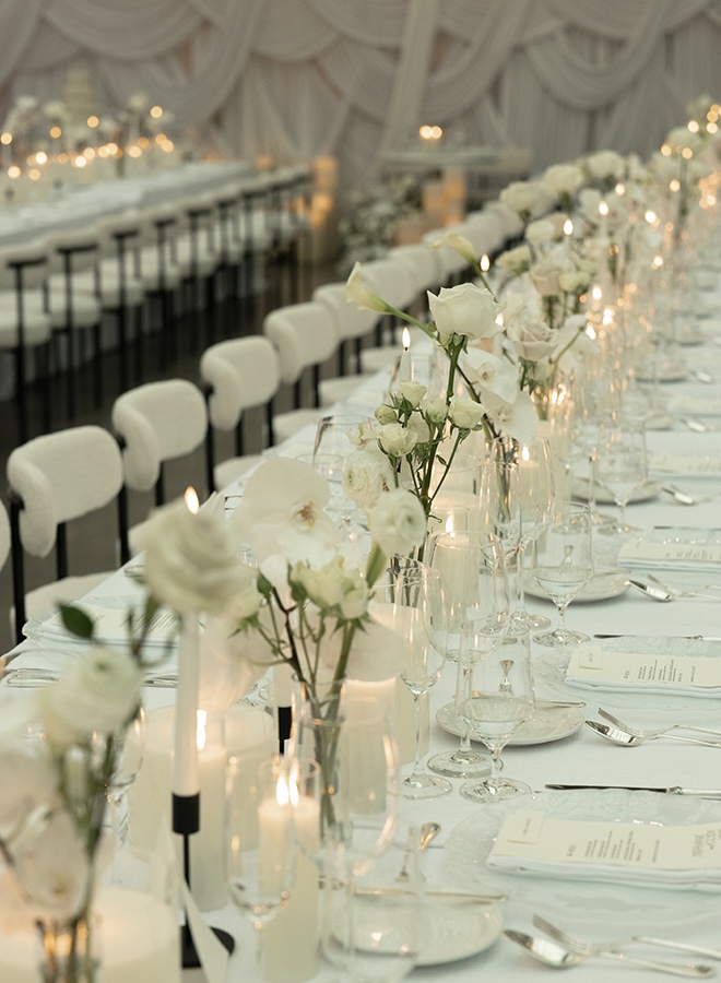 Candlelight and bud vases decorate the reception tables. 